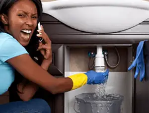 Emergency plumbing repair for a leaking sink drain under a bathroom vanity in Atlanta, GA