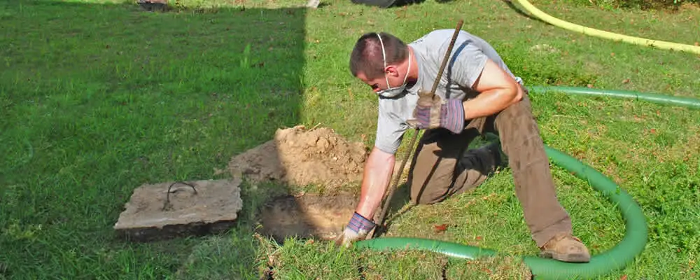 Septic pumping technician servicing a residential septic tank in Atlanta, GA